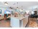 Spacious kitchen with a large center island, seating, and a seamless flow to the living and dining areas at 397 Woodgate Way, Summerville, SC 29485