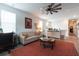 Bright living room featuring a comfortable sofa, decoratively accented coffee table, and a unique ceiling fan at 397 Woodgate Way, Summerville, SC 29485