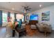 Comfortable living room featuring stylish sofas, a large TV, and bright windows with soft curtains at 397 Woodgate Way, Summerville, SC 29485