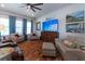 Comfortable living room featuring stylish sofas, a large TV, and bright windows with soft curtains at 397 Woodgate Way, Summerville, SC 29485