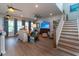 Stylish living room featuring an open staircase, comfortable furniture, and modern decor at 397 Woodgate Way, Summerville, SC 29485