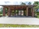 Covered brick pavilion with picnic tables offers a shaded space for gatherings and relaxation in this outdoor recreation area at 397 Woodgate Way, Summerville, SC 29485
