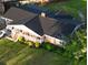 Aerial view of a brick home with mature landscaping and a large roof, showing a white car in the driveway at 404 Rose Ln, Summerville, SC 29485