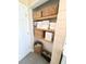 Bathroom closet with shelves stocked with towels, linens, woven baskets and a dog food container at 404 Rose Ln, Summerville, SC 29485