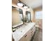 Bright bathroom with a modern double sink vanity, framed mirrors, modern lighting and shiplap walls at 404 Rose Ln, Summerville, SC 29485