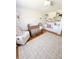 Bedroom featuring a wooden crib, a plush rocker and custom built-in shelves at 404 Rose Ln, Summerville, SC 29485
