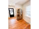 Entryway features a wooden cabinet, dark door, hardwood floors, and a wreath at 404 Rose Ln, Summerville, SC 29485