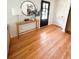 Bright entryway with round mirror, console table, black door and hardwood floors at 404 Rose Ln, Summerville, SC 29485