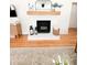 Close-up of stylish fireplace with wooden mantel, decorative mirror, and hardwood floors at 404 Rose Ln, Summerville, SC 29485