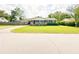 Charming single-story home with a well-manicured lawn, mature trees, and a classic brick facade at 404 Rose Ln, Summerville, SC 29485