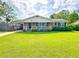Charming single-story brick home featuring a well-maintained lawn and inviting front porch at 404 Rose Ln, Summerville, SC 29485