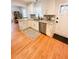 Updated kitchen with stainless appliances, white cabinetry, granite countertops, and hardwood floors at 404 Rose Ln, Summerville, SC 29485