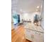 Bright kitchen adjacent to play area, featuring granite countertops and wood floors at 404 Rose Ln, Summerville, SC 29485