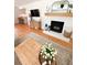 Living room with hardwood floors, a decorative fireplace and an eat-in kitchen area at 404 Rose Ln, Summerville, SC 29485