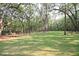 Spacious dog park with benches, trees, and well-maintained grassy area at 4151 Collins Dr, Charleston, SC 29414