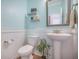 Stylish half bath featuring modern fixtures, soft blue walls, and classic wainscoting at 419 Whispering Breeze Ln, Summerville, SC 29486