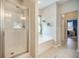 Bathroom featuring a walk-in shower and separate soaking tub under a bright window at 419 Whispering Breeze Ln, Summerville, SC 29486