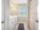 Bright bathroom features a double sink vanity with white cabinets and a shower with striped curtains at 419 Whispering Breeze Ln, Summerville, SC 29486