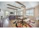 Open concept dining room with wood beams, shiplap wall, and view into the living area at 419 Whispering Breeze Ln, Summerville, SC 29486