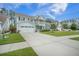 Lovely light blue home with a large driveway, green grass, and a quaint front balcony at 419 Whispering Breeze Ln, Summerville, SC 29486
