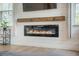 Close up of the modern electric fireplace with wood mantle and decorative shiplap in the living room at 419 Whispering Breeze Ln, Summerville, SC 29486