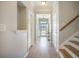 Inviting hallway with wood floors leads to a bright, naturally lit living space at 419 Whispering Breeze Ln, Summerville, SC 29486
