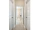 Neutral hallway featuring tile floor and framed doorways to the bath and other rooms at 419 Whispering Breeze Ln, Summerville, SC 29486