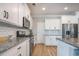 Kitchen with white cabinets, granite countertops, stainless steel appliances, and wood flooring at 419 Whispering Breeze Ln, Summerville, SC 29486