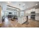 Open kitchen with white cabinets, granite island, and beams overlooking the dining and living area at 419 Whispering Breeze Ln, Summerville, SC 29486