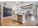 Open kitchen with island, stainless steel appliances, wood beams, chalkboard and open-concept living at 419 Whispering Breeze Ln, Summerville, SC 29486