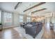 Open floor plan living room with natural light, a ceiling fan, wood beams, and access to the kitchen at 419 Whispering Breeze Ln, Summerville, SC 29486