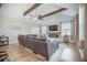 Open living room featuring vaulted ceiling, wood beams, a fireplace, large sectional sofa, and lots of natural light at 419 Whispering Breeze Ln, Summerville, SC 29486