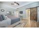 Stylish main bedroom boasts a sliding barn door, desk, and lots of bright, natural light at 419 Whispering Breeze Ln, Summerville, SC 29486