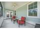 Inviting covered patio with comfortable seating, ceiling fan, offering a relaxing outdoor space at 419 Whispering Breeze Ln, Summerville, SC 29486