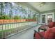 Relaxing screened porch featuring outdoor seating, ceiling fan, and a view of the fenced backyard at 419 Whispering Breeze Ln, Summerville, SC 29486