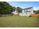 Expansive backyard features lush green grass, privacy fencing, and a charming two-story home at 4301 Trevor St, North Charleston, SC 29420