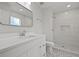 Bright bathroom with sleek white vanity and a modern walk-in shower with tiled walls at 4301 Trevor St, North Charleston, SC 29420