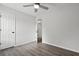 Cozy bedroom offering a ceiling fan and updated floors with a view to an ensuite at 4301 Trevor St, North Charleston, SC 29420