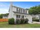 Two-story home with white siding, black shutters, manicured lawn, and inviting front porch at 4301 Trevor St, North Charleston, SC 29420
