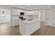Modern kitchen features white cabinetry, stainless steel appliances, and a center island with quartz countertops at 4301 Trevor St, North Charleston, SC 29420