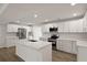 Modern kitchen features white cabinetry, stainless steel appliances, and a center island with quartz countertops at 4301 Trevor St, North Charleston, SC 29420