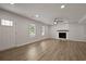 Bright living room featuring a fireplace, neutral walls, ceiling fan, and ample natural light from two windows at 4301 Trevor St, North Charleston, SC 29420