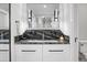 Modern bathroom features a marble countertop, a sleek mirror, and contemporary lighting at 4319 Sea Forest Dr, Kiawah Island, SC 29455