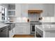 Modern kitchen with stainless steel appliances, quartz countertops, and sleek white cabinetry at 4319 Sea Forest Dr, Kiawah Island, SC 29455