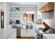 Well-lit kitchen featuring stainless steel appliances, ample counter space, and stylish open shelving at 4319 Sea Forest Dr, Kiawah Island, SC 29455