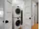 Modern, stacked washer and dryer unit with sleek design, seamlessly integrated within the well-maintained laundry area at 4319 Sea Forest Dr, Kiawah Island, SC 29455