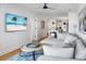 Bright and airy living room with a plush sofa, modern decor, and access to the kitchen area at 4319 Sea Forest Dr, Kiawah Island, SC 29455