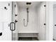 Modern glass shower stall is equipped with black matte hardware and features a built-in white bench at 4319 Sea Forest Dr, Kiawah Island, SC 29455