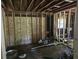 Unfinished room highlighting exposed beams, a new window, and wall studs, ready for customization and personalization at 436 W Butternut Rd, Summerville, SC 29483