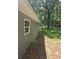The house's exterior shows the gray siding with a view of a backyard shed and a tree line at 436 W Butternut Rd, Summerville, SC 29483